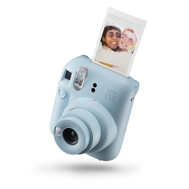 Fujifilm instax mini 12 instant camera in pastel blue with its round lens barrel and selfie mirror