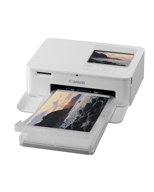 Canon SELPHY CP1500 with its postcard cassette fitted and its LCD screen lit