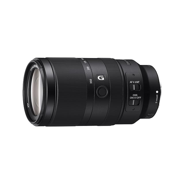 Sony SEL70350G super telephoto zoom in black with its focus hold button and focus mode switch