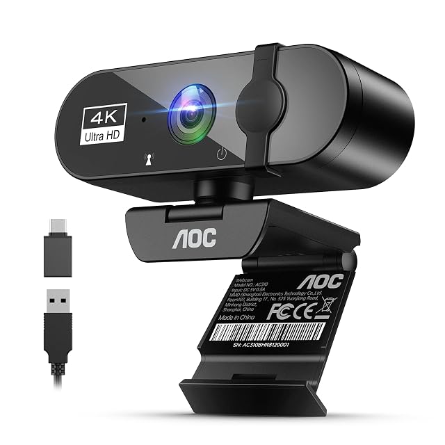 AOC AC310 black 4K webcam with a sliding lens cover, tilted upward on its clip